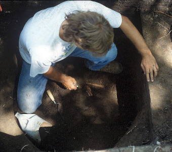 Excavation of a deer jaw in a storage or trash pit at the Quarry Creek site (summer 1991)