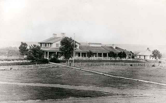 Two-storey Fort Riley hospital (ca. 1867) showing stone privy to right. (KansasMemory.org, Kansas Historical Society, Copy and Reuse Restrictions Apply)