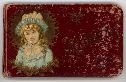 Maroon autograph book cover, featuring a young girl in a blue dress