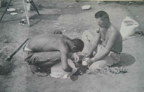 Two men making a plaster cover for an artifact at an archaeological excavation in 1953.