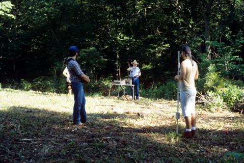 Two students receive instructions from Dr. John Weymouth in magnetometry survey of the Quarry Creek site (summer 1991)