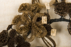 A flower on the hair wreath made of dark blonde hair